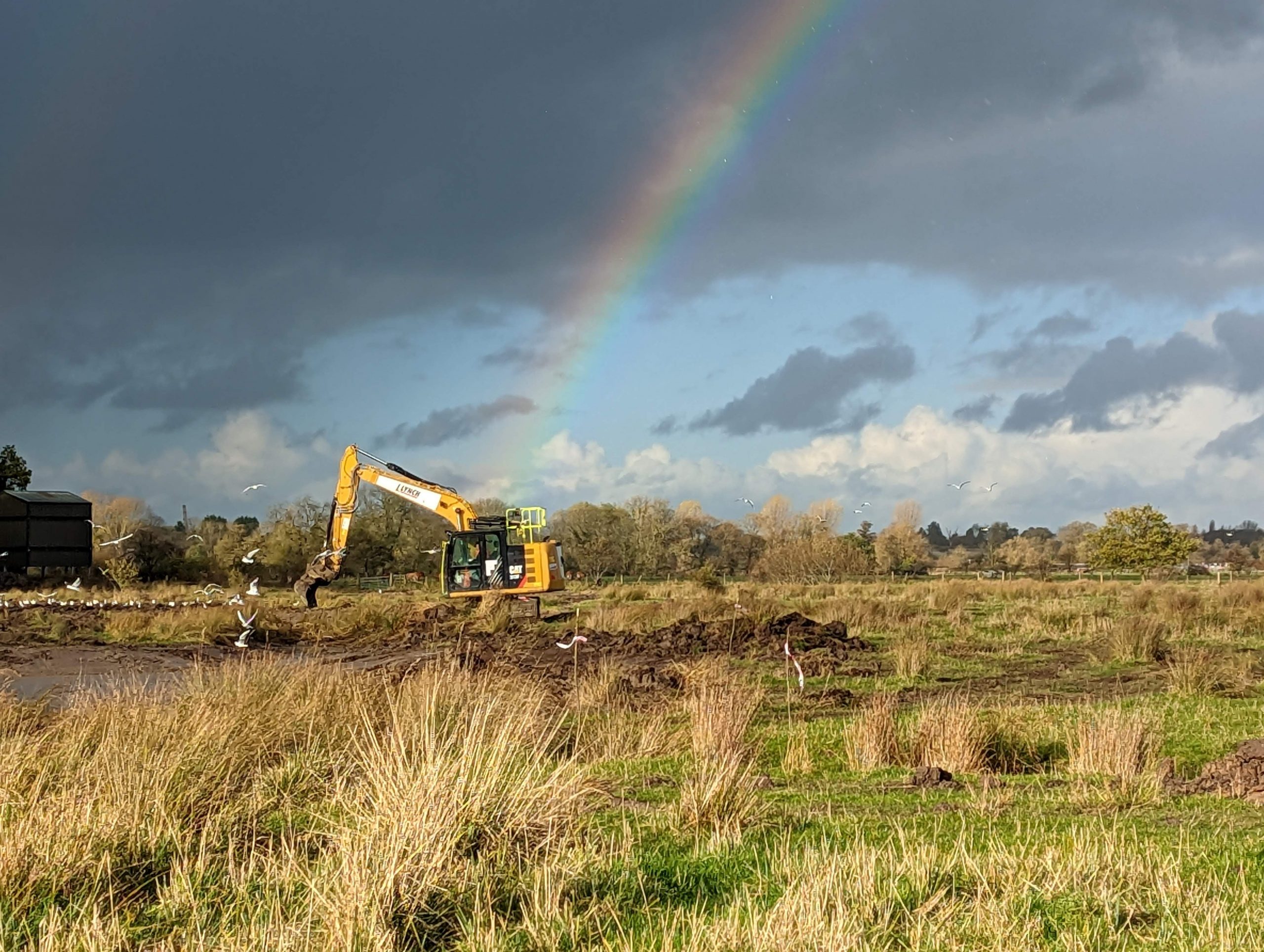 A digger with a rainbow overhead!