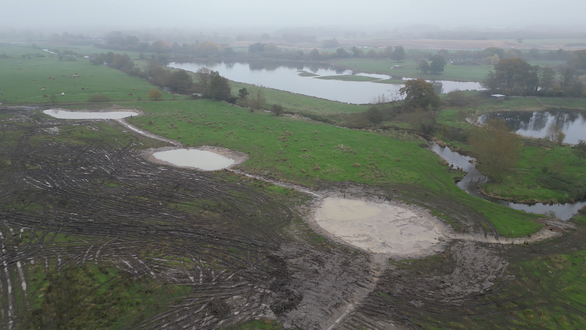 bird's eye view of the completed scrapes - a number of large shallow pools of water connected by thin streams called swales